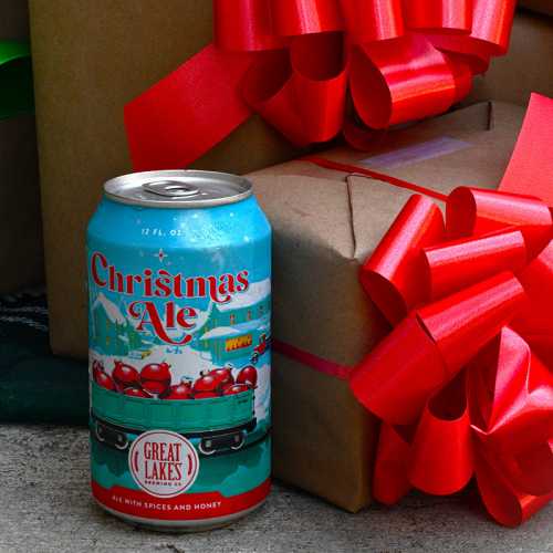 Christmas Ale can next to wrapped presents with ribbon