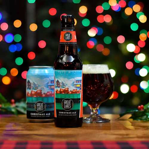 Christmas Ale Can, Bottle, and Snifter in front of lights with holly
